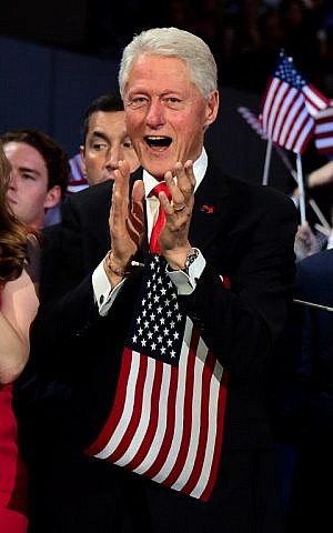 Former US President Bill Clinton applauds as US Democratic Presidential Candidate Hillary Clinton speaks during the final day of the 2016 Democratic National Convention on July 28, 2016, at the Wells Fargo Center in Philadelphia, Pennsylvania. (AFP PHOTO / Robyn BECK)