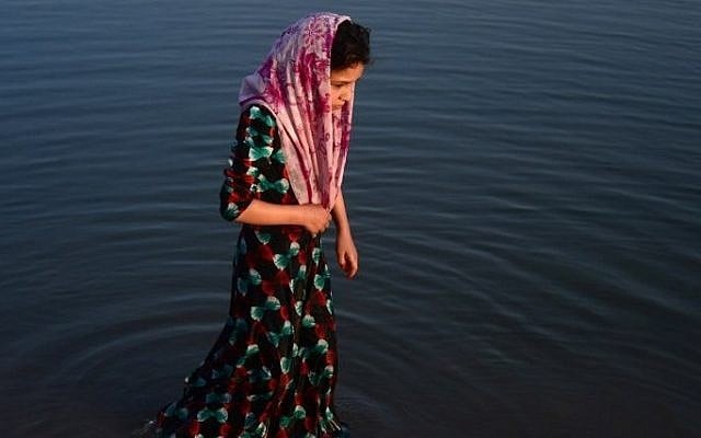 Illustrative: In this photograph taken on July 28, 2016, an Afghan girl stands in the Hari Rud river on the outskirts of Herat. (AFP/Aref Karim) Illustrative: In this photograph taken on July 28, 2016, an Afghan girl stands in the Hari Rud river on the outskirts of Herat. (AFP/Aref Karim)