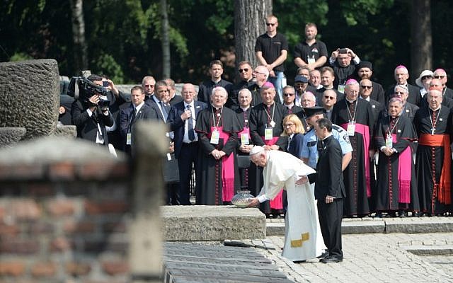Pope Francis places a memorial candle at a monument in the Auschwitz death camp in Poland on July 29, 2016. (AFP/Filippo Monteforte)