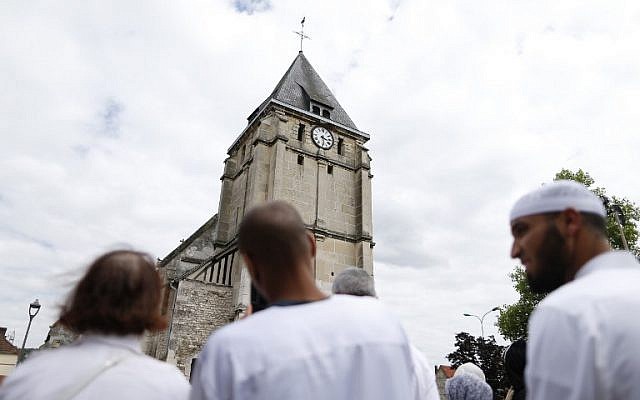Muslims put flowers and hold a minute of silence on July 29, 2016 in front of the church if Saint-Etienne-du-Rouvray, western France, where French priest Jacques Hamel was killed on July 26 in the church during a hostage-taking claimed by Islamic State group.
(AFP/Charly Triballeau) Muslims put flowers and hold a minute of silence on July 29, 2016 in front of the church if Saint-Etienne-du-Rouvray, western France, where French priest Jacques Hamel was killed on July 26 in the church during a hostage-taking claimed by Islamic State group.
(AFP/Charly Triballeau)
