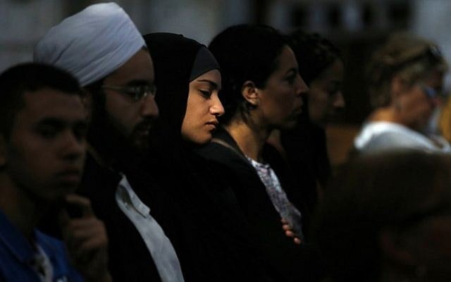 A Muslim woman looks on as people attend Mass in tribute to priest Jacques Hamel in the Rouen Cathedral on July 31, 2016. (AFP/Charly Triballeau) A Muslim woman looks on as people attend Mass in tribute to priest Jacques Hamel in the Rouen Cathedral on July 31, 2016. (AFP/Charly Triballeau)