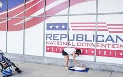 Shannon Holter, a resident of Chagrin Falls, waves an American flag at her six month old son, Ethan, outisde of Quicken Loans Arena on July 11, 2016 in Cleveland, Ohio ahead of the Republican National Convention.  (Angelo Merendino/Getty Images/AFP