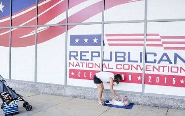 Shannon Holter, a resident of Chagrin Falls, waves an American flag at her six month old son, Ethan, outisde of Quicken Loans Arena on July 11, 2016 in Cleveland, Ohio ahead of the Republican National Convention. (Angelo Merendino/Getty Images/AFP Shannon Holter, a resident of Chagrin Falls, waves an American flag at her six month old son, Ethan, outisde of Quicken Loans Arena on July 11, 2016 in Cleveland, Ohio ahead of the Republican National Convention. (Angelo Merendino/Getty Images/AFP