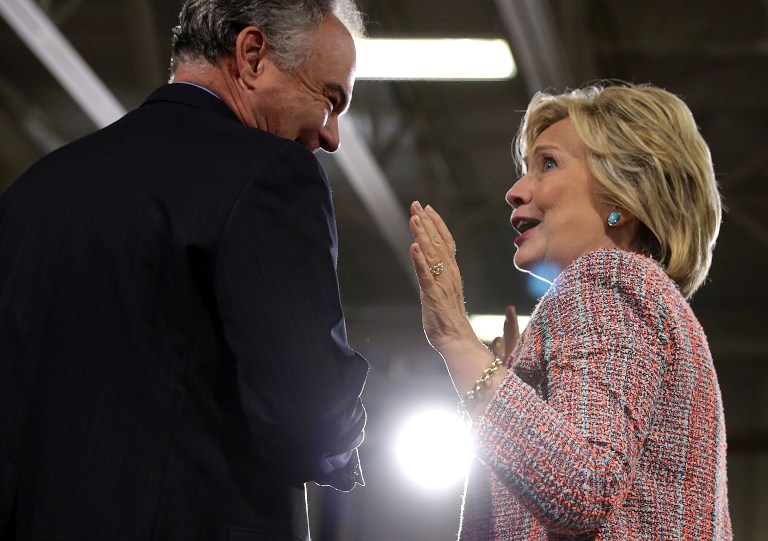 Democratic presidential candidate Hillary Clinton (R) and US Sen. Tim Kaine (D-VA) (L) share a moment during a campaign event at Ernst Community Cultural Center at Northern Virginia Community College July 14, 2016 in Annandale, Virginia. (Alex Wong/Getty Images/AFP)