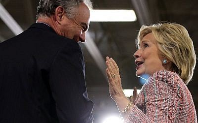 Presumptive Democratic nominee Hillary Clinton (R) and US Sen. Tim Kaine (D-VA) (L) share a moment during a campaign event at Ernst Community Cultural Center at Northern Virginia Community College July 14, 2016 in Annandale, Virginia. (Alex Wong/Getty Images/AFP)
