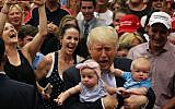 Republican presidential nominee Donald Trump reacts as he holds of three-month-old Kellen Campbell, of Denver, right, while holding six-month-old Evelyn Keane, of Castle Rock, Colo., after Trump's speech at the Gallogly Event Center on the campus of the University of Colorado on July 29, 2016 in Colorado Springs, Colorado.  (Joe Mahoney/Getty Images/AFP)