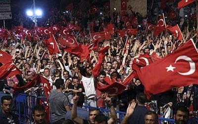 Supporters listen to Turkey's President Recep Tayyip Erdogan as he addresses them in front of his residence in Istanbul, early Tuesday, July 19, 2016. (Kayhan Ozer/Pool Photo via AP)