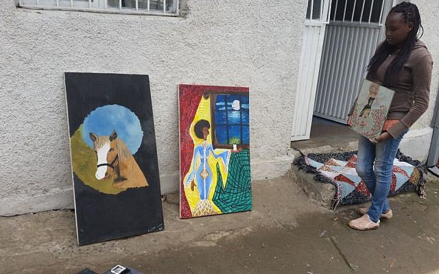 Rahel Nunu showing her art to visiting Israeli journalist at the AHOPE Center for HIV positive orphans in Addis Ababa, July 7, 2016 (Raphael Ahren)