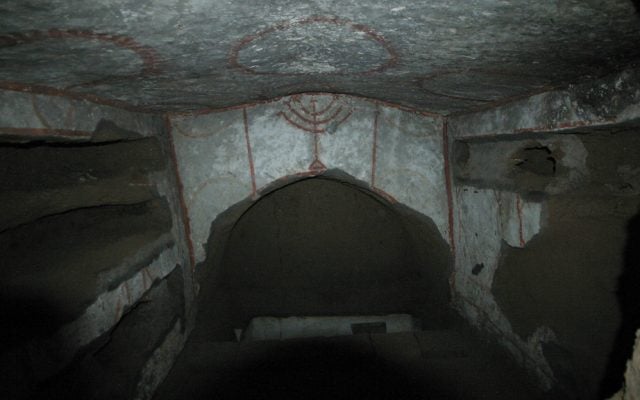 The painting of a menorah is one of several clues as to the Jewish origin of the Catacombe di Vigna Randanini. (Rossella Tercatin/Times of Israel)