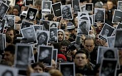 People hold up pictures of those who died in the AMIA Jewish center bombing that killed 85 people as they commemorate the attack's 22nd anniversary in Buenos Aires, Argentina, July 18, 2016. (AP Photo/Natacha Pisarenko)