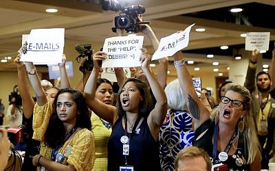 Protesters yell as DNC Chairwoman, Debbie Wasserman Schultz, D-Fla., arrives for a Florida delegation breakfast, Monday, July 25, 2016, in Philadelphia, during the first day of the Democratic National Convention. (AP Photo/Matt Slocum)