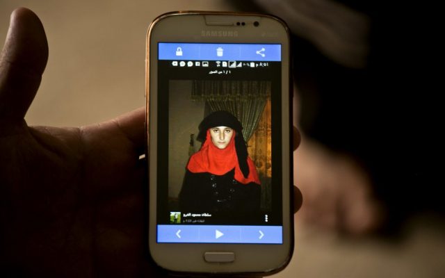 Islamic State group militants took this photo of Yazidi girl Nazdar Murat, as part of a database the militants have put together of Yazidi girls and women they have enslaved, shown in this May 18, 2016, photo taken during an interview with her family at Kankhe Camp for the internally displaced in Dahuk, northern Iraq. The Associated Press obtained a batch of 48 headshots of enslaved girls, smuggled out by one who escaped. “They register every slave, every person under their owner, and therefore if she escapes, every Daesh control or checkpoint ... they know that this girl ... has escaped from this owner,” said Mirza Danai, founder of the aid organization Luftbrucke Irak, using the Arabic term for IS. (AP Photo/Maya Alleruzzo)
