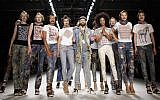 Designer Johny Dar, center, and the models receive the applause after the 'Jeans For Refugees project' fashion show Friday, July 1, 2016.  (AP Photo/Markus Schreiber)