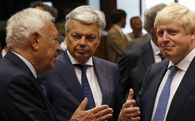 Newly appointed British Foreign Secretary Boris Johnson, right, speaks with Belgium's Foreign Minister Didier Reynders, center, and Spanish Foreign Minister Jose Manuel Margallo before the EU foreign ministers meeting in Brussels, Belgium, Monday, July 18, 2016. (AP Photo/Darko Vojinovic)