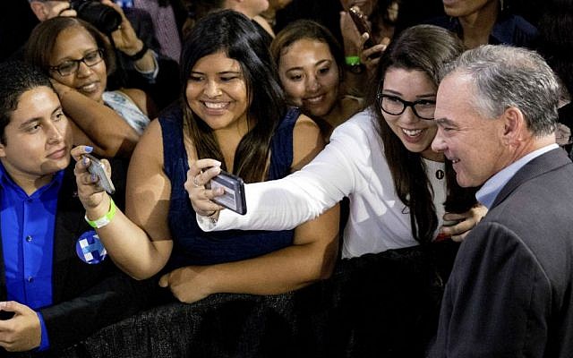 Democratic running mate Sen. Tim Kaine, D-Virginia, right, takes a photograph with a member of the audience after speaking at a rally with Democratic presidential candidate Hillary Clinton at Florida International University Panther Arena in Miami, Saturday, July 23, 2016. (AP Photo/Andrew Harnik)