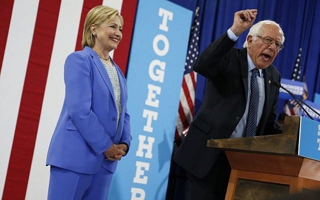 Democratic presidential candidate Hillary Clinton listens as Sen. Bernie Sanders, I-Vt. speaks during a rally in Portsmouth, N.H. on July 12, 2016, where Sanders endorsed Clinton. (AP Photo/Andrew Harnik)