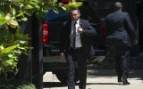 Secret Service stand guard around a Secret Service vehicle after it arrived at the home of Democratic presidential candidate Hillary Clinton in Washington, Saturday, July 2, 2016 (AP Photo/Cliff Owen)