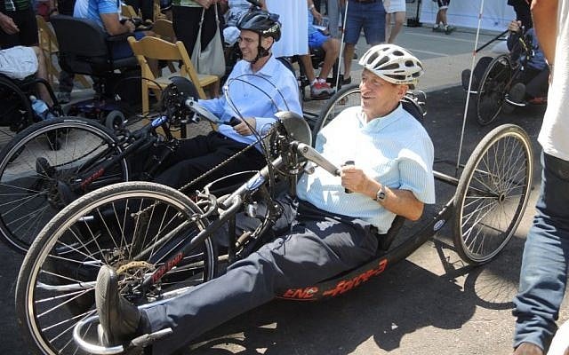 Tourism Minister Yariv Levin (left) and Tel Aviv Mayor Ron Huldai try out hand cycles on newly-adapted accessible bike paths at the dedication of the Accessible Cycling Complex on July 28, 2016. (Melanie Lidman/Times of Israel) Tourism Minister Yariv Levin (left) and Tel Aviv Mayor Ron Huldai try out hand cycles on newly-adapted accessible bike paths at the dedication of the Accessible Cycling Complex on July 28, 2016. (Melanie Lidman/Times of Israel)