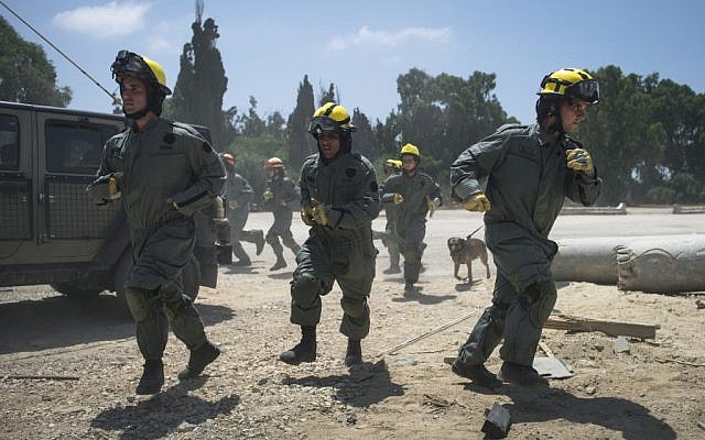 Soldiers in the IDF Home Front Command's search and rescue units run to the scene of a pretend rocket strike during a large-scale exercise in Zikim near the Gaza border on July 3, 2016. (IDF Spokesperson's Unit)