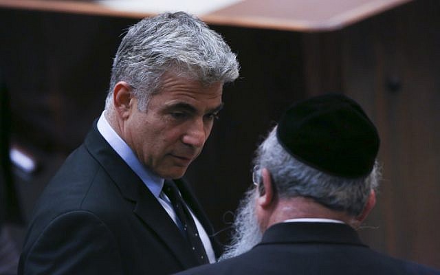 Yesh Atid leader Yair Lapid seen speaking with United Torah Judaism parliament member Menachem Eliezer Mozes on July 08, 2013. (Yonatan Sindel/FLASH90) Yesh Atid leader Yair Lapid seen speaking with United Torah Judaism parliament member Menachem Eliezer Mozes on July 08, 2013. (Yonatan Sindel/FLASH90)