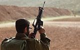 Illustrative: An IDF soldier holding a weapon. (Yaakov Naumi/Flash90)