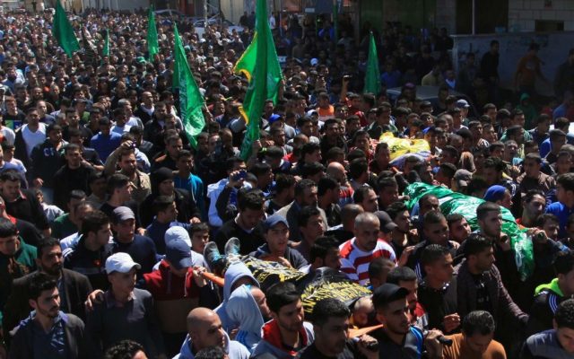 Palestinians carry two bodies during the funerals of Yazan Basim, Mahmoud Abu Zena and Hamza Abu Al-Haija, at Jenin Refugee Camp in the West Bank on March 22, 2014. (Issam Rimawi/Flash90)
