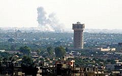 Smoke rises after an airstrike in the Sinai city of Rafah as seen from Gaza on July 1, 2015. (Abed Rahim Khatib /Flash90)