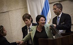 Joint List party member Hanin Zoabi is removed by Knesset security during her speech at a plenum session in the Knesset on February 8, 2016. (Hadas Parush/Flash90)