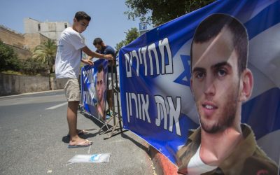 Brother of late Israeli soldier Oron Shaul seen at a protest tent outside the Prime Minister Benjamin Netanyahu's residence in Jerusalem on June 30, 2016. The sign reads 'Returning Oron.' (Photo by Yonatan Sindel/Flash90)