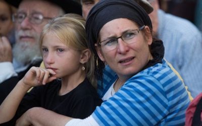 Rina Ariel and a younger daughter mourning during her funeral ceremony in the Jewish settlement of Kiryat Arba, in the West Bank, on June 30, 2016.  (Yonatan Sindel/Flash90)
