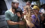 The children of Rabbi Miki Mark mourn at a service prior to his funeral at the Otniel yeshiva, where he was a principal, July 3, 2016. Shlomo Mark is on the left. (Hadas Parush/FLASH90)