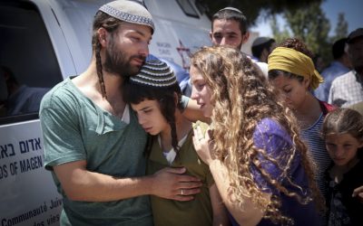 The children of Rabbi Miki Mark mourn at a service prior to his funeral at the Otniel yeshiva, where he was a principal, July 3, 2016. (Hadas Parush/FLASH90)