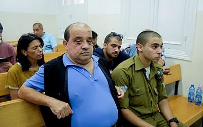 Elior Azaria, an Israeli soldier on trial for manslaughter, with his father Charlie, at a military court in Jaffa, July 06, 2016. (Flash90)