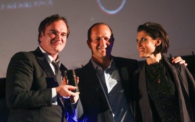 American filmmaker and actor Quentin Tarantino (left) receiving an award from Jerusalem Mayor Nir Barkat (center) and Jerusalem Cinematheque director Noa Regev (right) at the opening night of the Jerusalem Film Festival, on July 7, 2016. (Hadas Parush/Flash90) American filmmaker and actor Quentin Tarantino (left) receiving an award from Jerusalem Mayor Nir Barkat (center) and Jerusalem Cinematheque director Noa Regev (right) at the opening night of the Jerusalem Film Festival, on July 7, 2016. (Hadas Parush/Flash90)