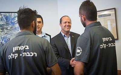 Jerusalem District Police Commander, Yoram Halevi, second left, and Jerusalem mayor Nir Barkat, second right, meet and congratulate light rail security guards who prevented a bombing on July 17, 2016. (Miriam Alster/Flash90)