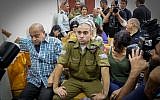 Sgt. Elor Azaria,center, an Israeli soldier who killed a Palestinian stabber in Hebron, seen during a court hearing at a military court in Jaffa, July 26, 2016. (Flash90)