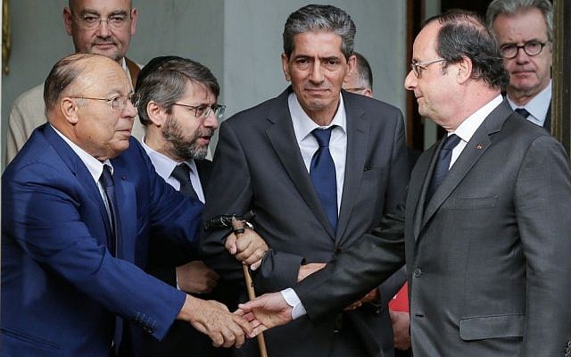 French President Francois Hollande shakes hands with Paris Mosque rector Dalil Boubakeur, left, after a meeting with religious representatives at the Elysee Palace in Paris, following yesterday attack at a church in Normandy, Wednesday, July 27, 2016. (AP Photo/Thomas Padilla) 