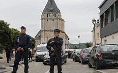 French riot police guards the street to access the church where an hostage taking left a priest dead in Saint-Etienne-du-Rouvray, Normandy, France, Tuesday, July 26, 2016. (AP Photo/Francois Mori)