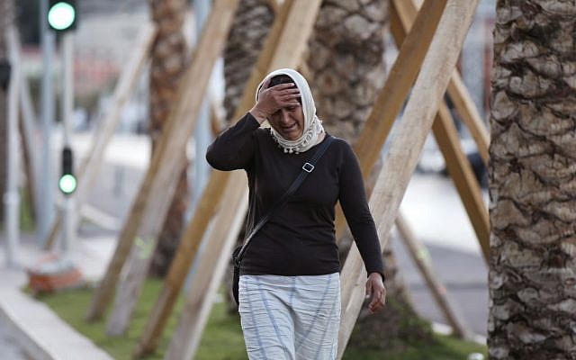 A woman seeking her son near the scene of an attack after a truck drove onto the sidewalk and plowed through a crowd of revelers watching the Bastille Day fireworks in Nice, France, July 15, 2016. (AP/Luca Bruno)