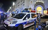 A police car is parked near the scene of a terror attack after a truck drove on to the sidewalk and plowed through a crowd of revelers who'd gathered to watch the fireworks in the French resort city of Nice, southern France, Friday, July 15, 2016. (AP Photo/Christian Alminana)