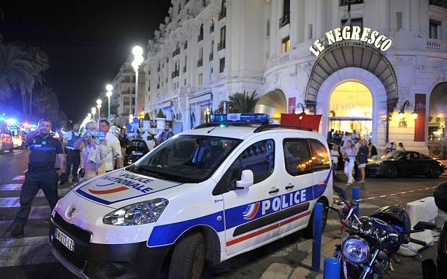 A police car is parked near the scene of an attack after a truck drove on to the sidewalk and plowed through a crowd of revelers who'd gathered to watch the fireworks in the French resort city of Nice, southern France, Friday, July 15, 2016(AP Photo/Christian Alminana)