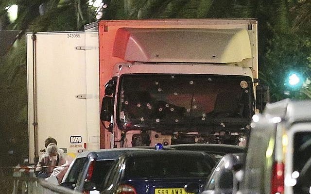 A policeman stands, watching the truck used for the attack near the scene of an attack after a truck drove onto the sidewalk late Thursday, and plowed through a crowd of revelers who gathered to watch the fireworks in the French resort city of Nice, southern France, Friday, July 15, 2016. (AP Photo/Luca Bruno) A policeman stands, watching the truck used for the attack near the scene of an attack after a truck drove onto the sidewalk late Thursday, and plowed through a crowd of revelers who gathered to watch the fireworks in the French resort city of Nice, southern France, Friday, July 15, 2016. (AP Photo/Luca Bruno)