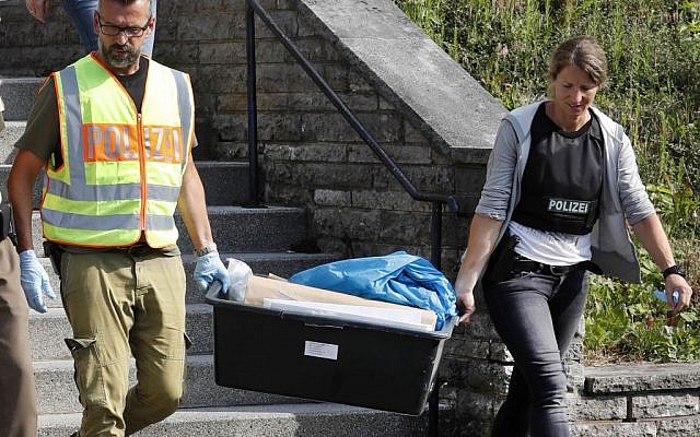 Police officers leave a former hotel where a Syrian man lived before the explosion in Ansbach, Germany, Monday, July 25, 2016. (AP Photo/Matthias Schrader) Police officers leave a former hotel where a Syrian man lived before the explosion in Ansbach, Germany, Monday, July 25, 2016. (AP Photo/Matthias Schrader)