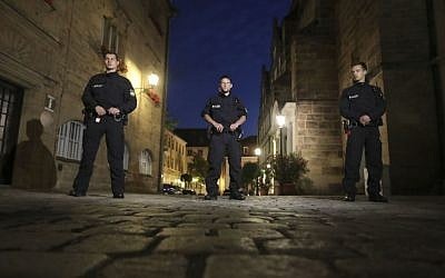 Police officers secure the area after a bomb attack in Ansbach, Germany, Monday, July 25, 2016. (AP Photo/Matthias Schrader)