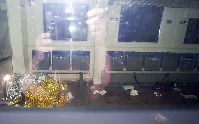 Blood stains and a rescue blanket are seen through the windows of a train in Wuerzburg, southern Germany, after a 17-year-old Afghan attacked passengers with an axe and a knife, July 18, 2016. (Karl-Josef Hildenbrand/dpa via AP)