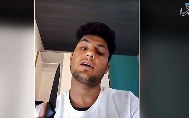 This still image taken July 20 from an undated video posted on The Aamaq news agency, which is affiliated to the Islamic State group, purports to show a 17-year-old Afghan asylum-seeker who attacked people with an ax and knife on a train in southern Germany, making a statement in Pashto while brandishing a knife. (Militant video via AP) This still image taken July 20 from an undated video posted on The Aamaq news agency, which is affiliated to the Islamic State group, purports to show a 17-year-old Afghan asylum-seeker who attacked people with an ax and knife on a train in southern Germany, making a statement in Pashto while brandishing a knife. (Militant video via AP)