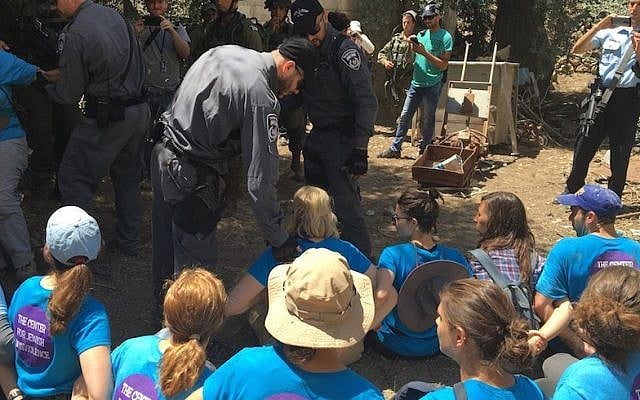 Israeli authorities removing activists from the Center for Jewish Nonviolence from property in the West Bank city of Hebron, July 16, 2016. (Andrew Tobin)