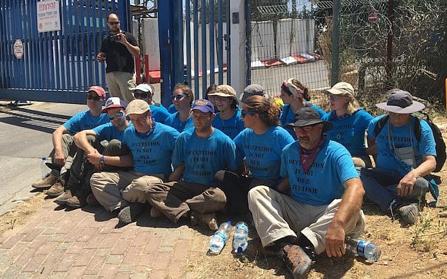 Ethan Buckner, second from left in front, and other activists from the Center for Jewish Nonviolence protesting outside the jail in the West Bank Jewish settlement Kiryat Arba, July 16, 2016. (Andrew Tobin)