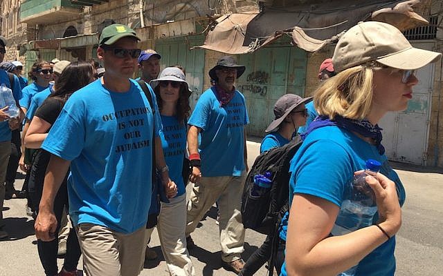 Illustrative: Peter Beinart, left, marching with other activists from the Center for Jewish Nonviolence through the West Bank city of Hebron, July 16, 2016. On the right is the movement’s CEO, Ilana Sumka. (Andrew Tobin) Illustrative: Peter Beinart, left, marching with other activists from the Center for Jewish Nonviolence through the West Bank city of Hebron, July 16, 2016. On the right is the movement’s CEO, Ilana Sumka. (Andrew Tobin)