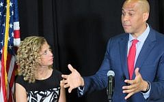 Sen. Cory Booker, D-NJ, right, speaks out against what he calls the “hate” emanating from the republican convention in Cleveland while Rep. Debbie Wasserman Schultz, D-Fla, the chairwoman of the Democratic National Committee, looks on, on July 21, 2016. (Ron Kampeas)